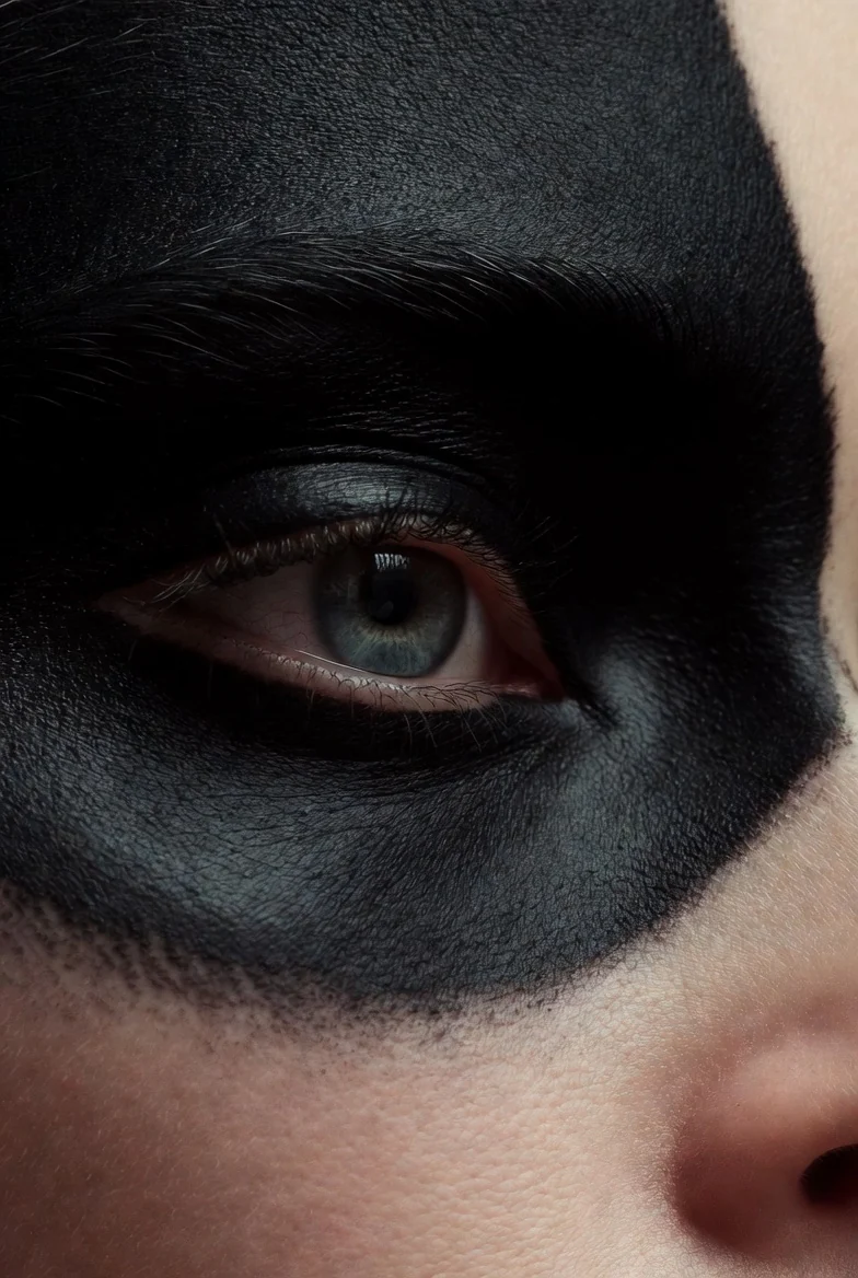 Close-up of an eye framed by dark makeup